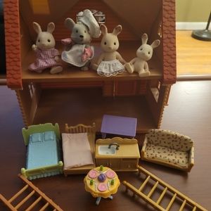 Calico critters/Sylvanian figures and cottage.